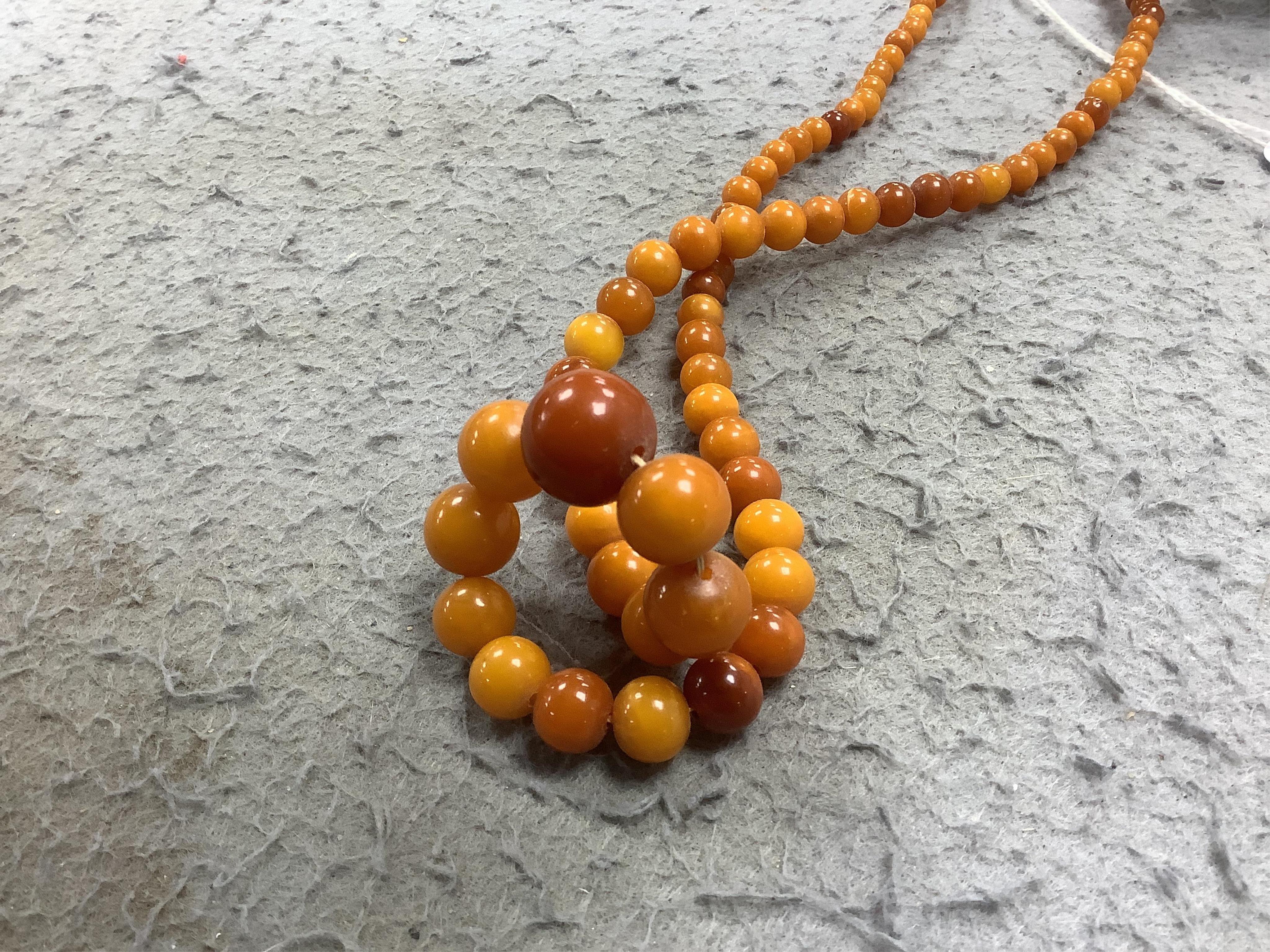 An amber bead necklace, composed of graduated amber beads measuring approximately 15.7-3.6mm, length 58cm, gross weight 23 grams. Condition: overall good, some minor crazing, some minor wear, commensurate with age